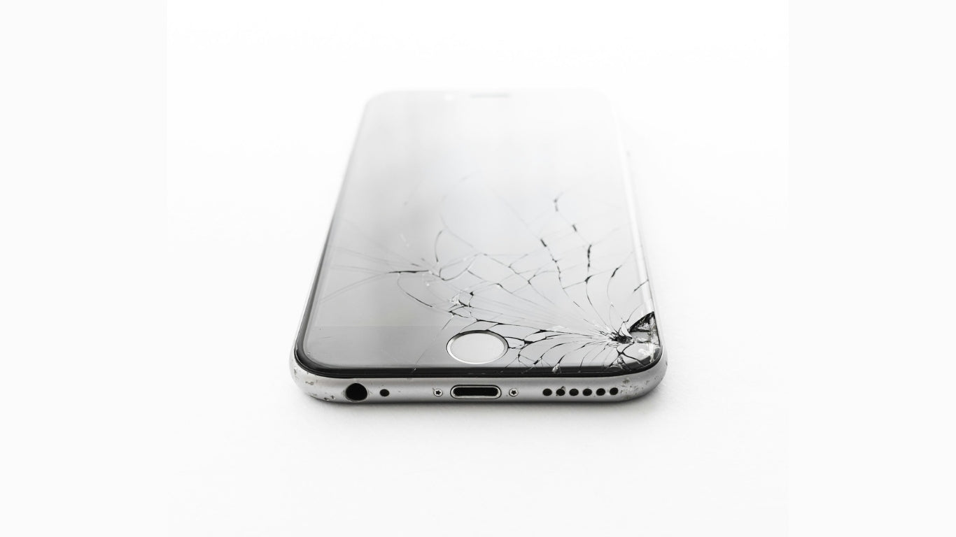 Close-up of an iPhone with a cracked screen, highlighting how easily iPhone displays can get damaged from drops or impact.