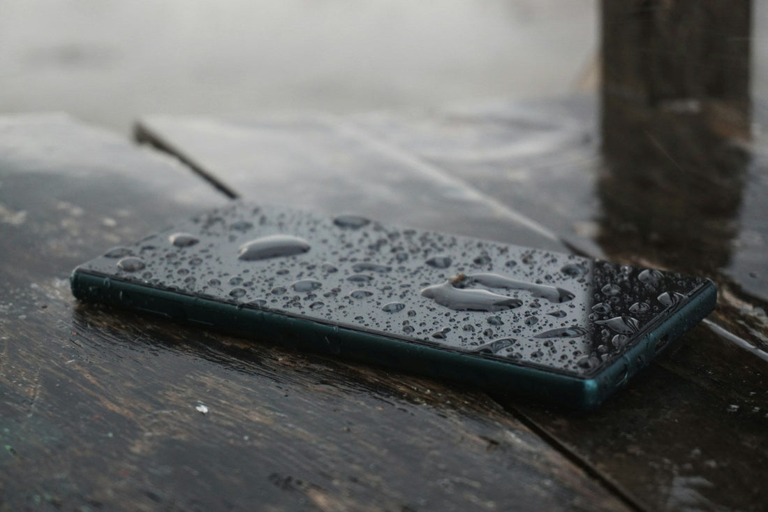 Close-up of a water-damaged smartphone with visible screen moisture and corrosion, illustrating the need for professional phone repair.