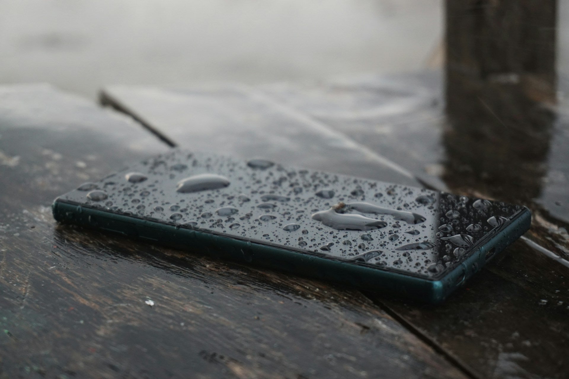 Close-up of a water-damaged smartphone with visible screen moisture and corrosion, illustrating the need for professional phone repair.