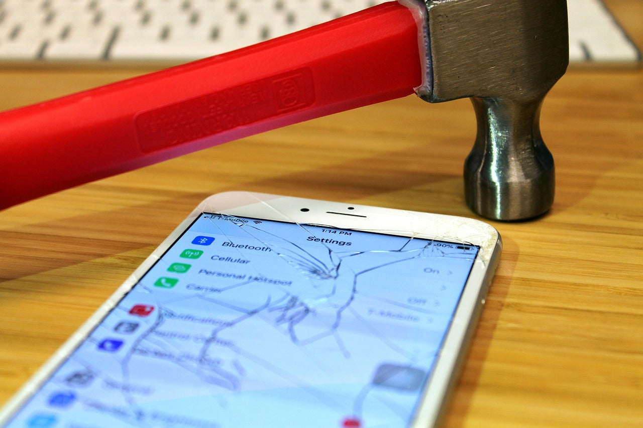 Close-up of a broken iPhone screen highlighting damage before repair