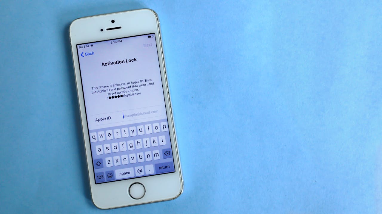 iPhone screen displaying Activation Lock message, requesting Apple ID password to unlock the device.