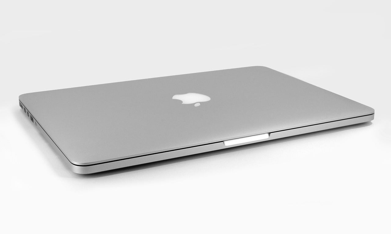 MacBook Pro 16-inch (2021) placed on a sleek surface, showcasing its premium design and large Retina display.