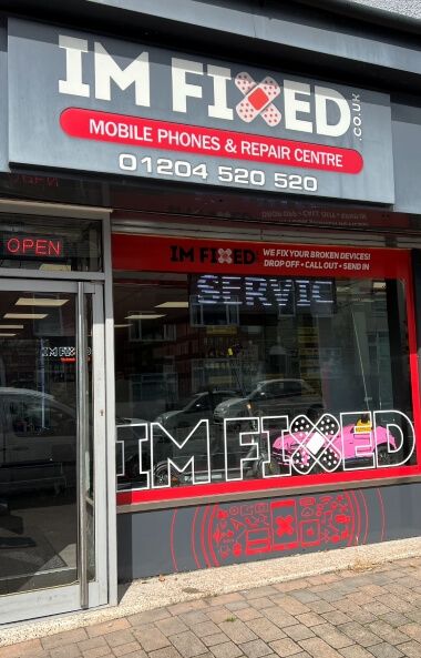IM FIXED mobile phones and repair center storefront with contact information.